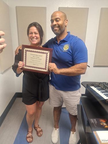 Richard Swann and Adrienne LaValley holding the recording studio plaque.