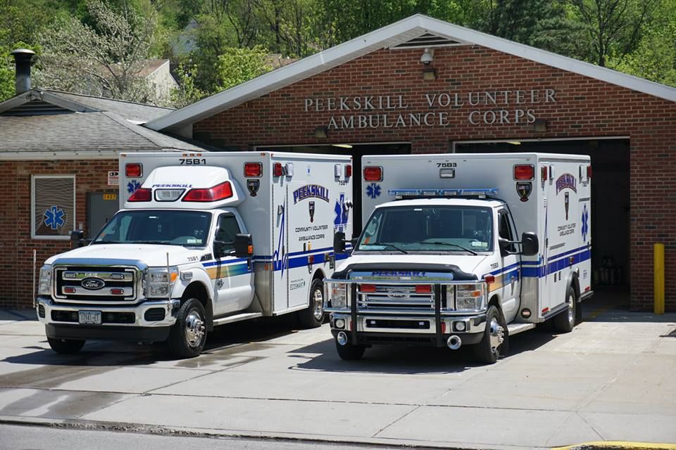 Ambulance trucks in front of garages.