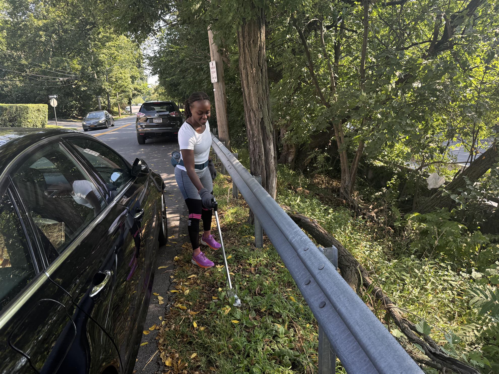 Club member and Westchester County Legislator Shanae Williams picking up trash along Midland Avenue in Yonkers