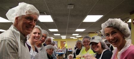 WE JOIN AREA CLUBS TO PACKAGE MEALS FOR COMMUNITY FOOD PANTRIES