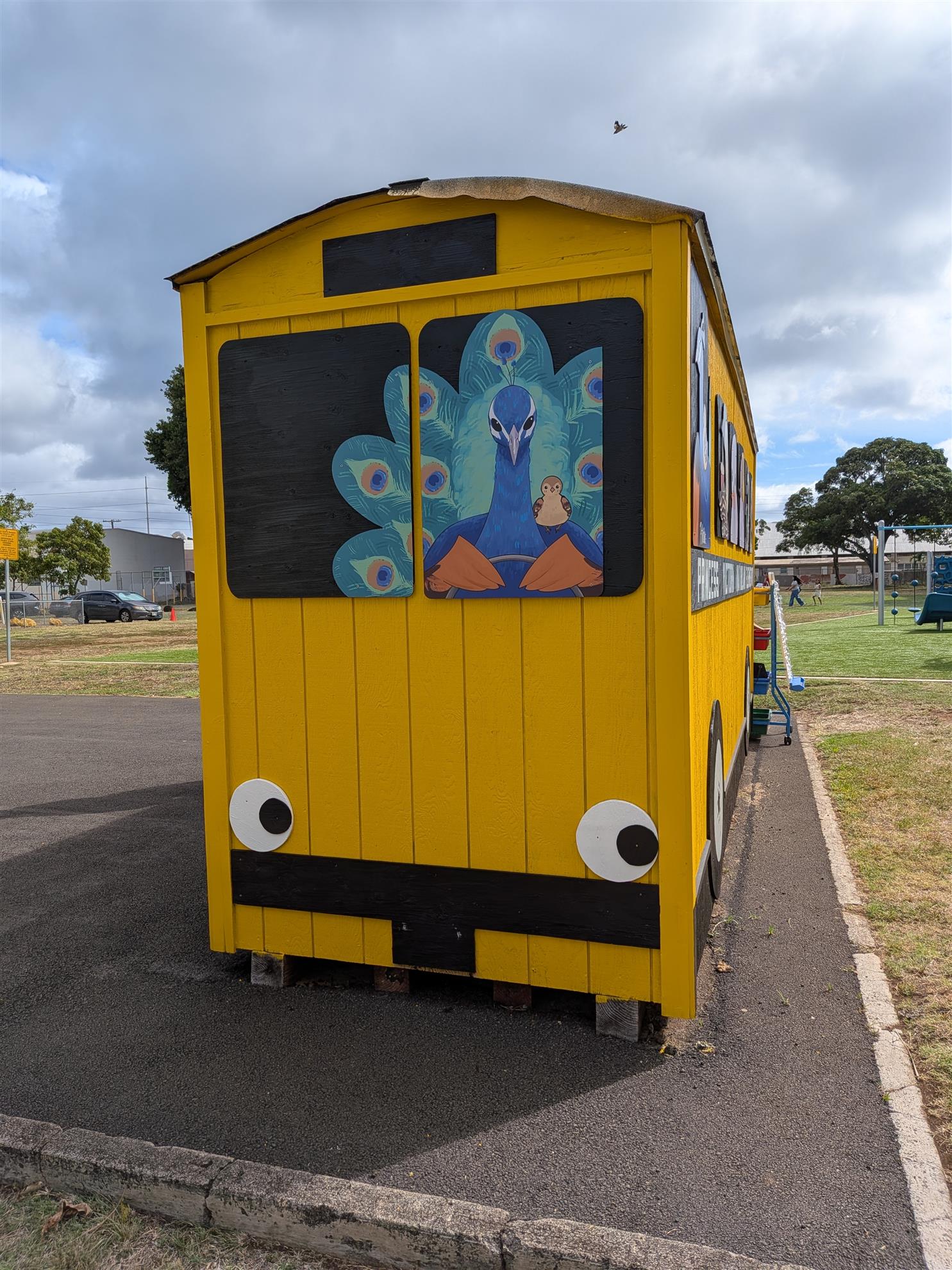 The front of the Peacock Bus with peacock artwork and painted headlights