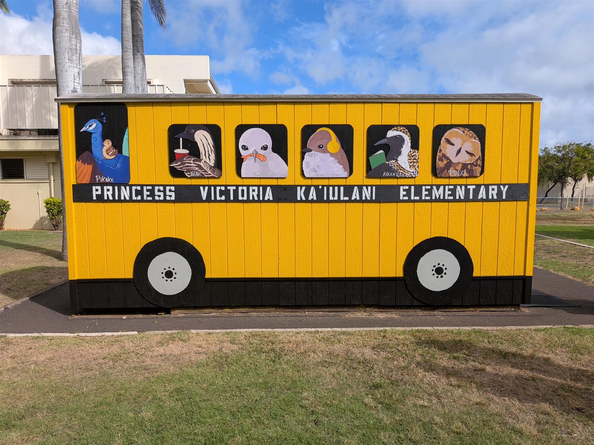The restored yellow Peacock Bus with Hawaiian bird artwork