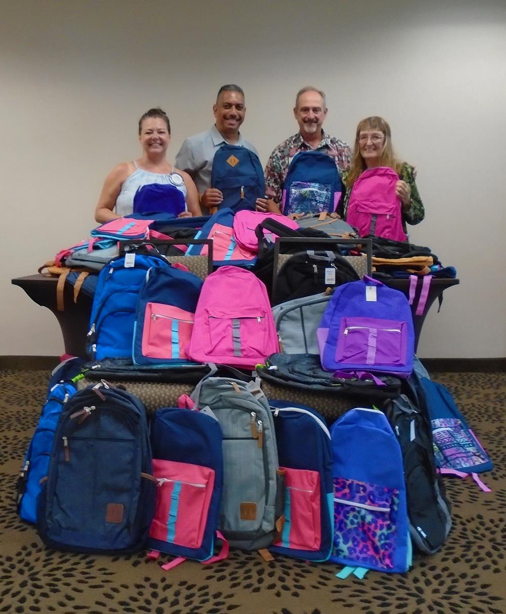 Officer Van Reyes of the Hawaii County Police Dept. accepting the backpacks