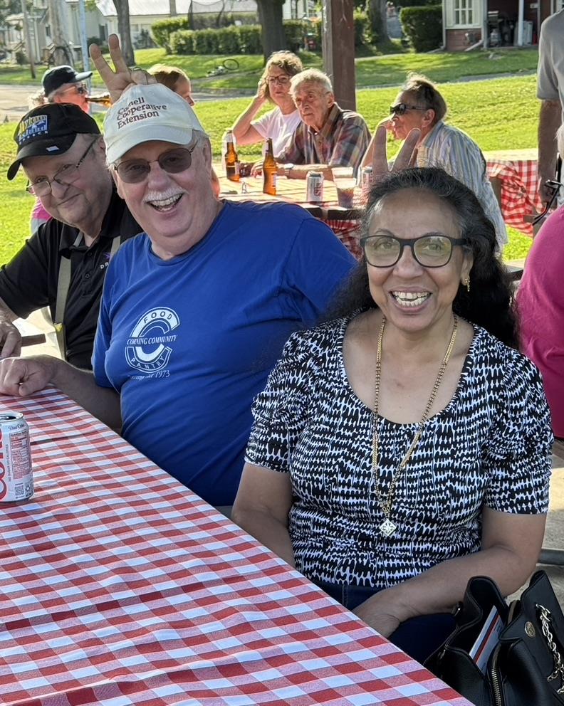 A group of people standing around a table