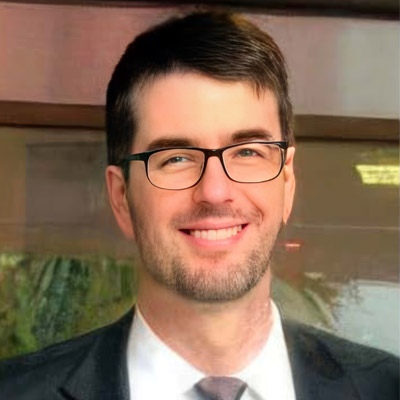 A person wearing glasses and a suit

AI-generated content may be incorrect.