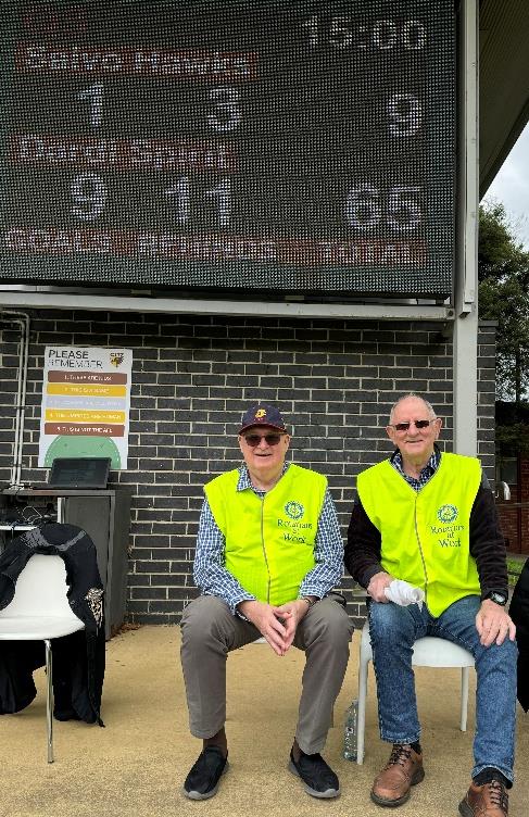 Two men in yellow vests sitting in front of a brick building

AI-generated content may be incorrect.