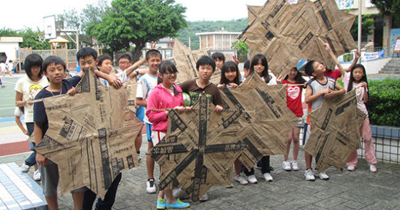 Students show off their construction skills by making kites out of newspapers during classes supported by the Rotary Science Education Program.