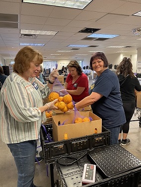 Betty-Lisa-and-Denice-bagging-oranges_20230629-234300.JPG