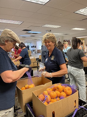 Christine-bagging-oranges_20230629-233750.JPG