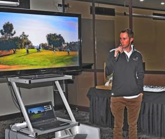 Brad Steinert  giving his talk to the Rotary Club of Waikerie.  Background image of golf course on a TV screen.