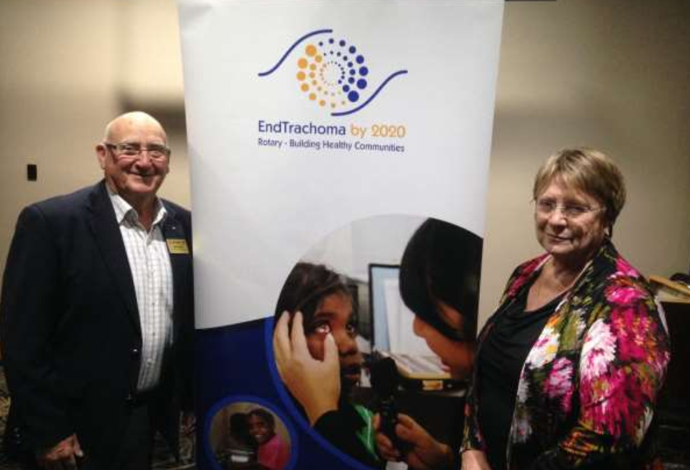Chairperson Ian and Jenny Mills in front of "End Trachoma" banner.