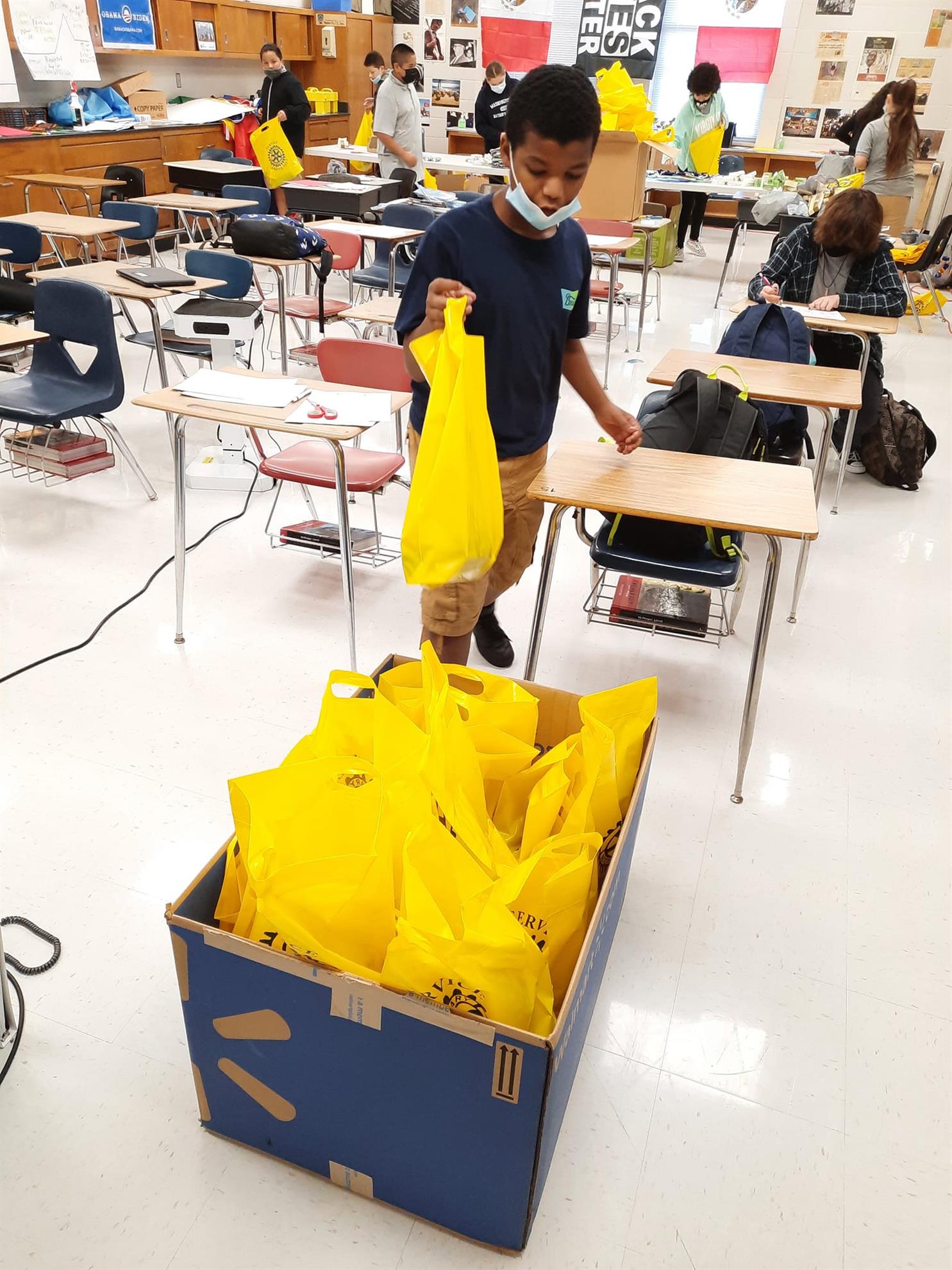 Students from FD Moon Middle School prepare hygiene kits for our club