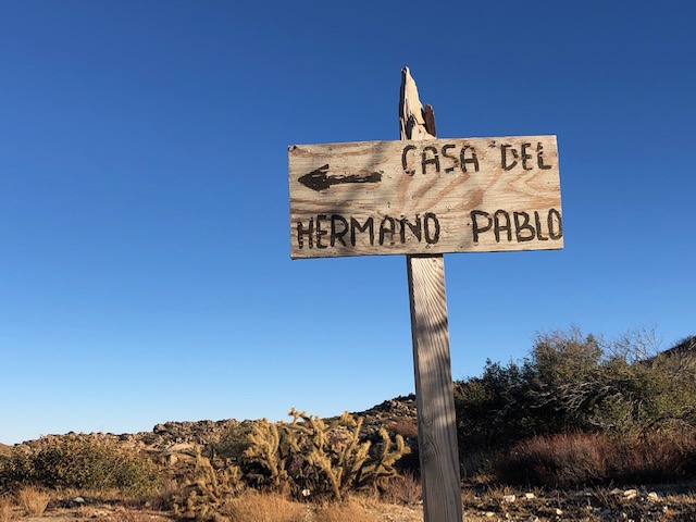 Hand-painted wooden sign points the way to Casa Del Hermano Pablo.