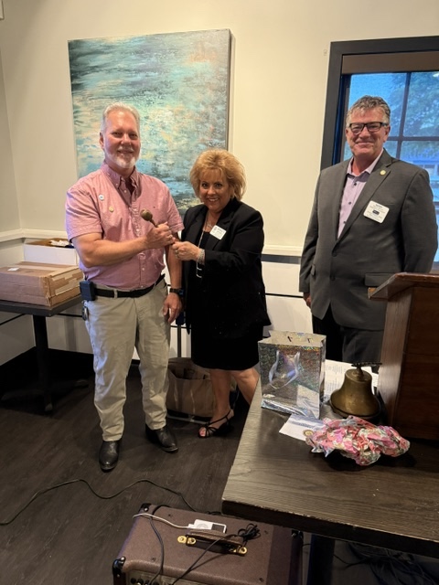 Chris giving Bernadette Symbolic Past President Gavel