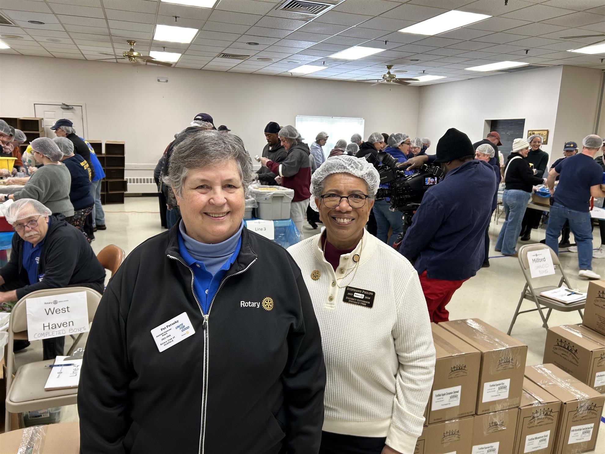 District Governor Stephanie Philips and Stratford Rotarian Pat Patusky at Meal Packing Event