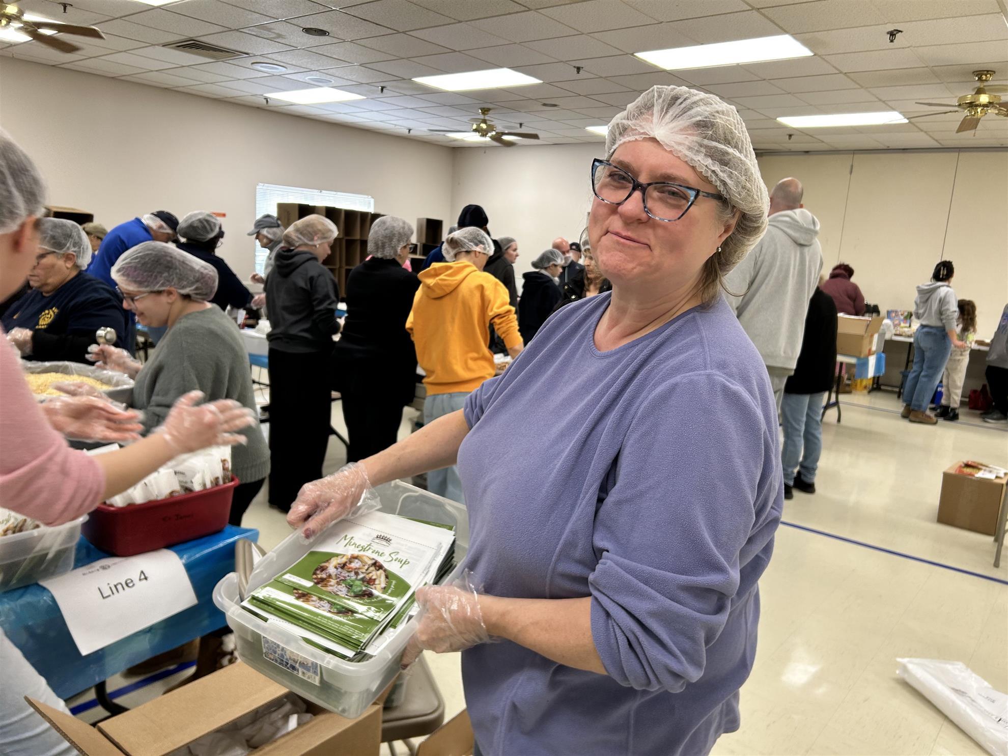 Stratford Rotarian Sheri Szymanski busy with Meal Packing Event