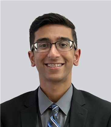 A person wearing glasses and a suit

AI-generated content may be incorrect.