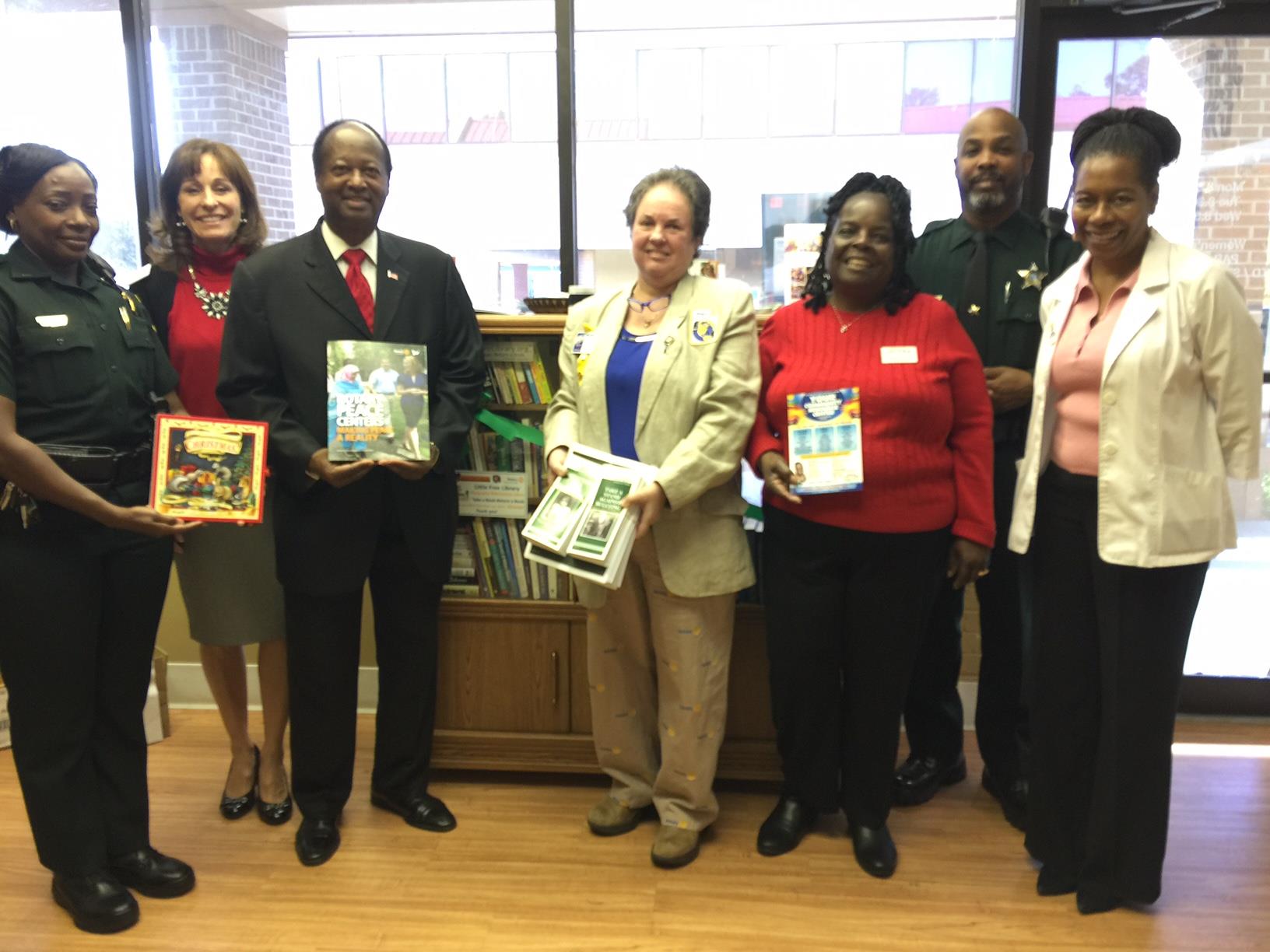 Lt Frost, Congressman Webster's rep Cindy Brown, Orl Comm Ings, DrO, Ansar of Charity & Love, ACorp Stanley Murray add to the Little Free Library.