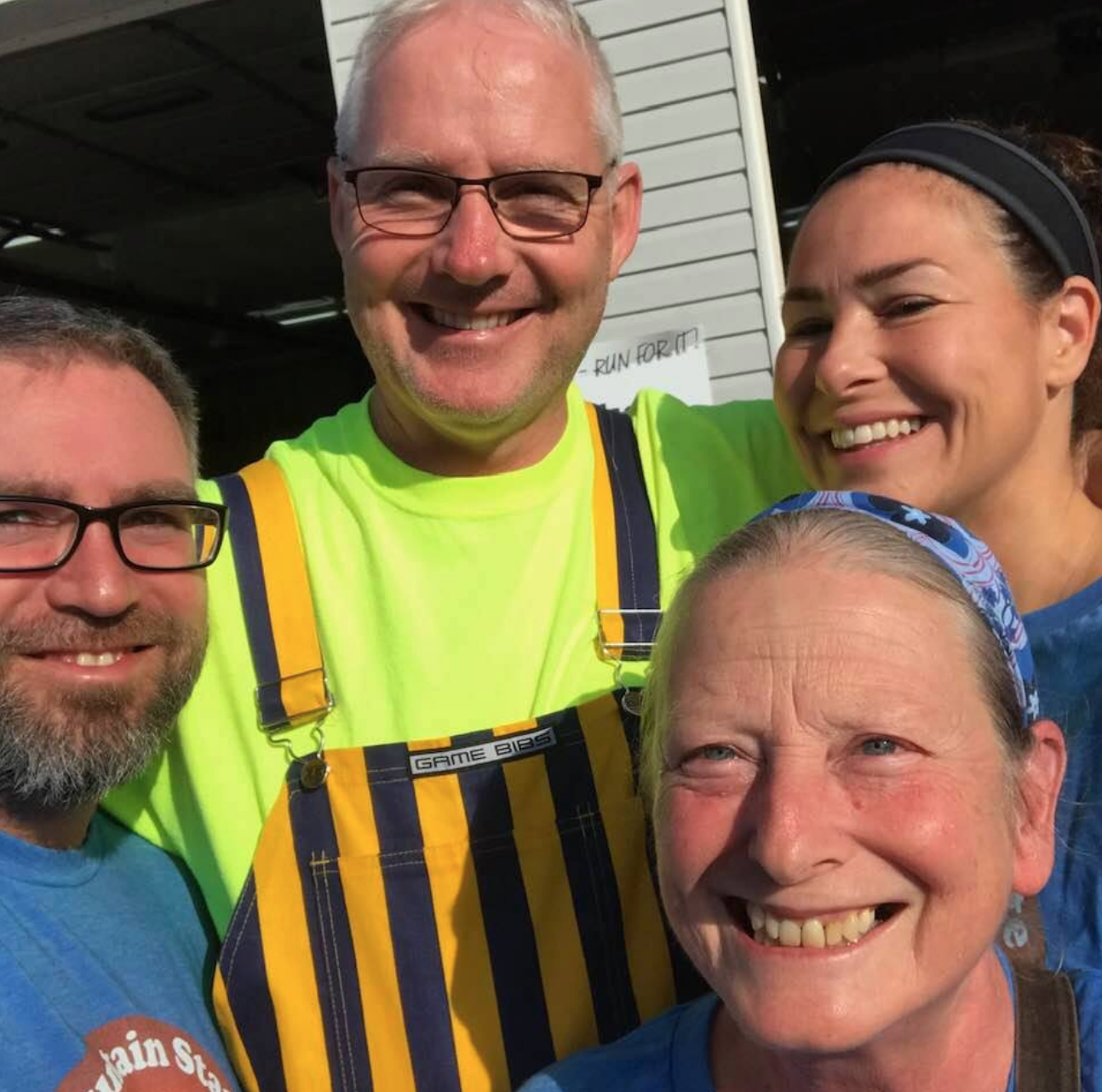 Running for Rotary! Shawn (L) and Andrea Fleming (upper right) with DGN David Cooper (center). E-Club President Bonnie Branciaroli (front) walked the 2K.