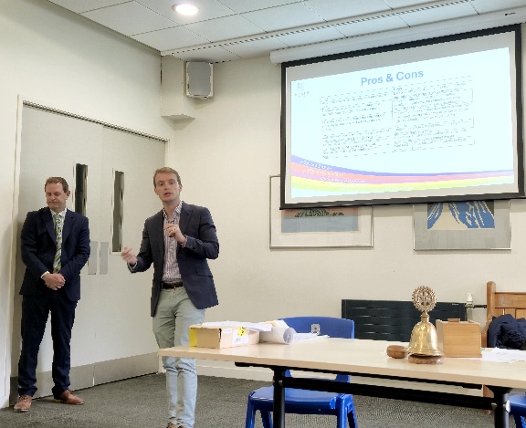 A group of men in a roomAI-generated content may be incorrect.