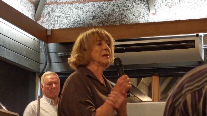 A person holding a microphoneAI-generated content may be incorrect.