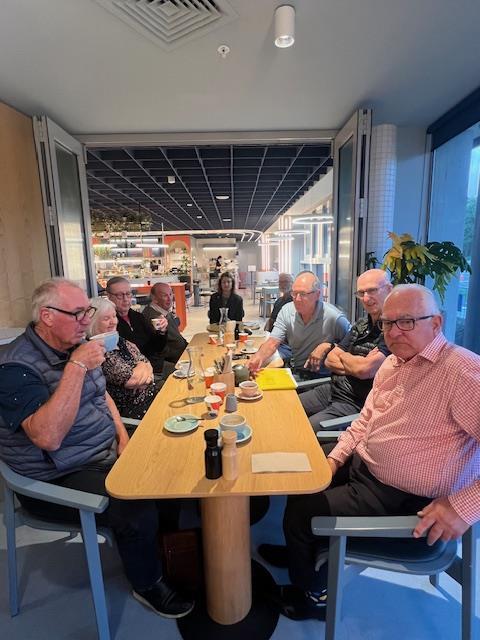 Members around a table at a club get-together