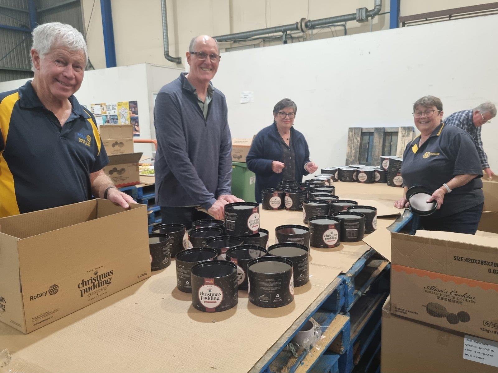 Members packing Rotary Christmas puddings
