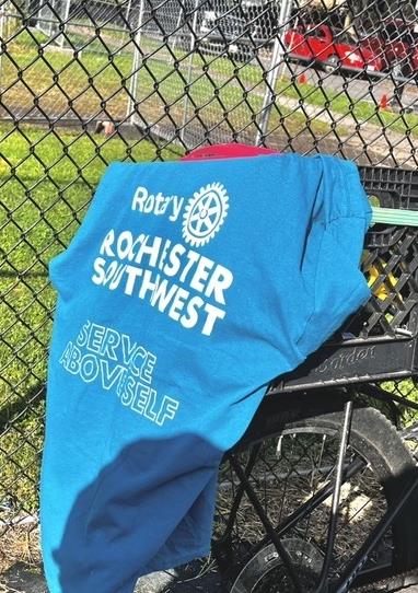 A Rochester Southwest Rotary shirt proudly displays our motto, “Service Above Self,” at the KABOOM! playground build—a fitting reminder of the spirit of volunteerism that brings our community together.