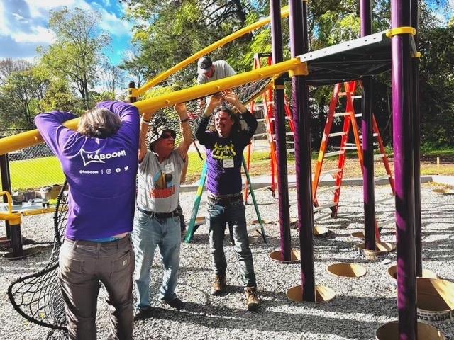 Volunteers installing the yellow playground structure.