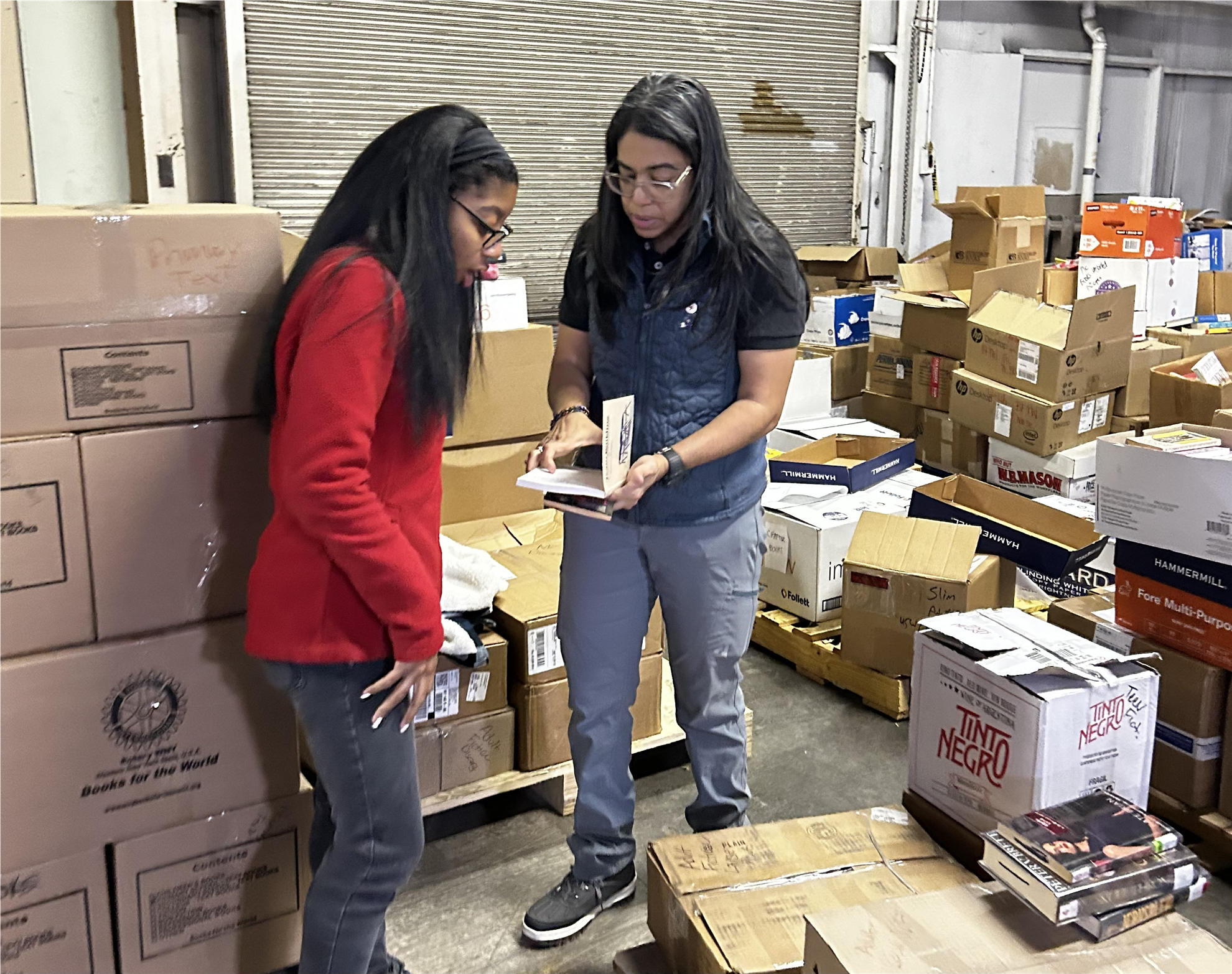 Club member Wanda Martinez-Johncox and her daugther, Marie, determine the category of a book.