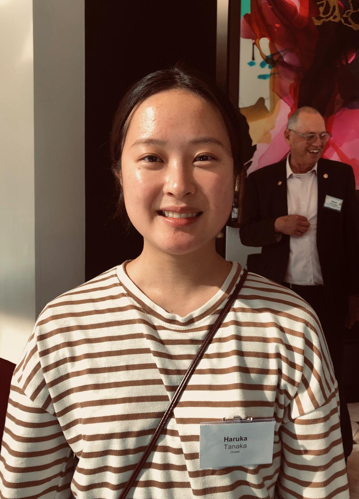 A person smiling at cameraDescription automatically generated