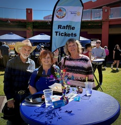 Del Rae selling raffle tickets to Debbie and Ray Schwartz