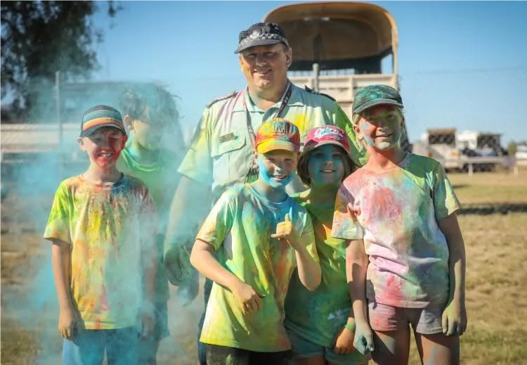 Dion Horn with children at the colour run
