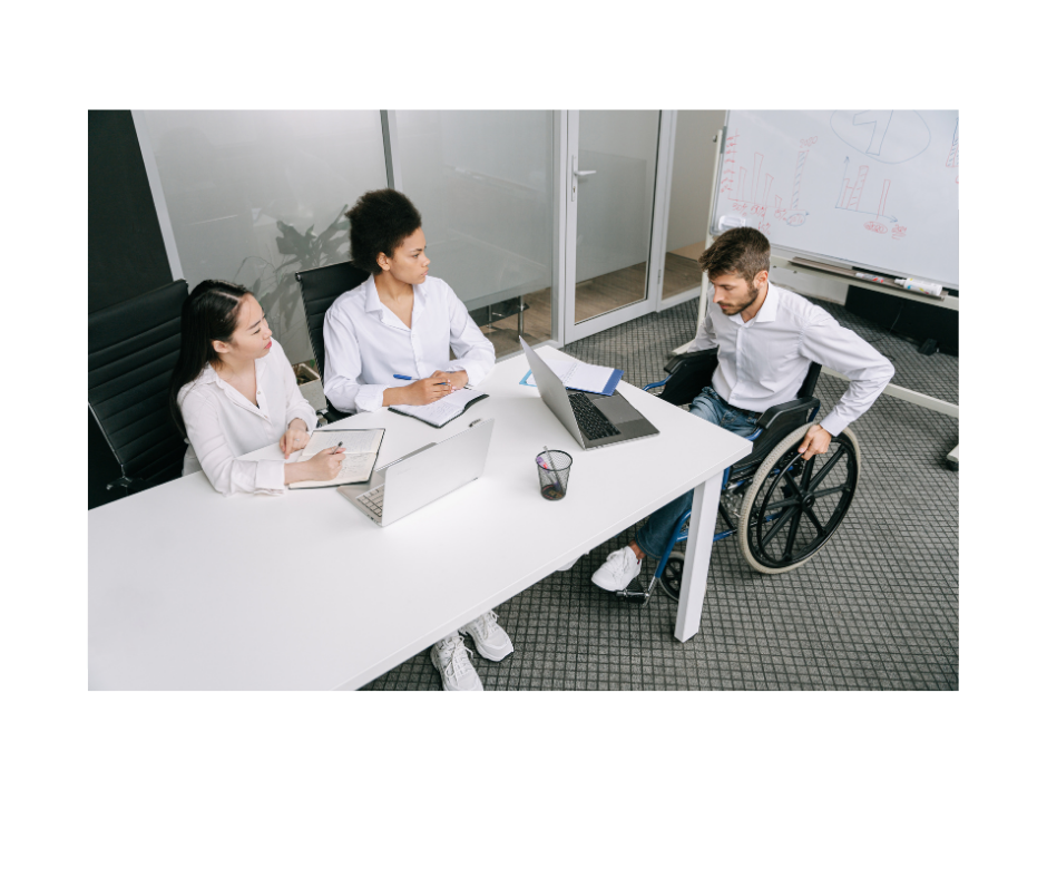 Diverse and inclusive team in a meeting, including a colleague who uses a wheelchair