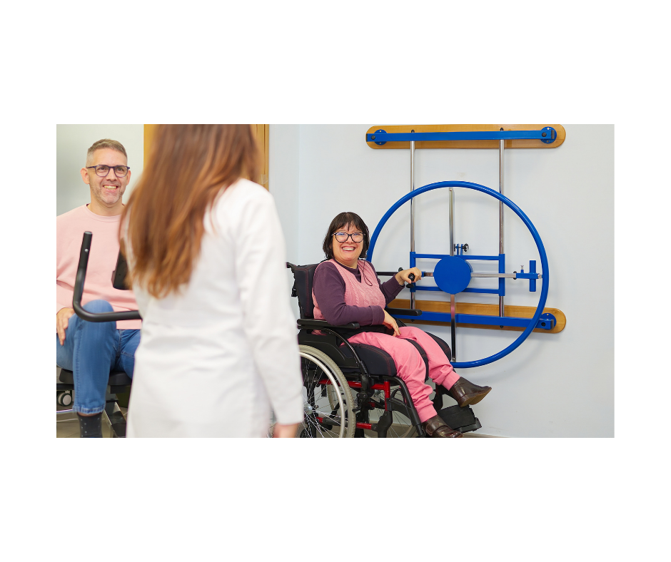 A person using a wheelchair working with a physical therapist during a rehabilitation session