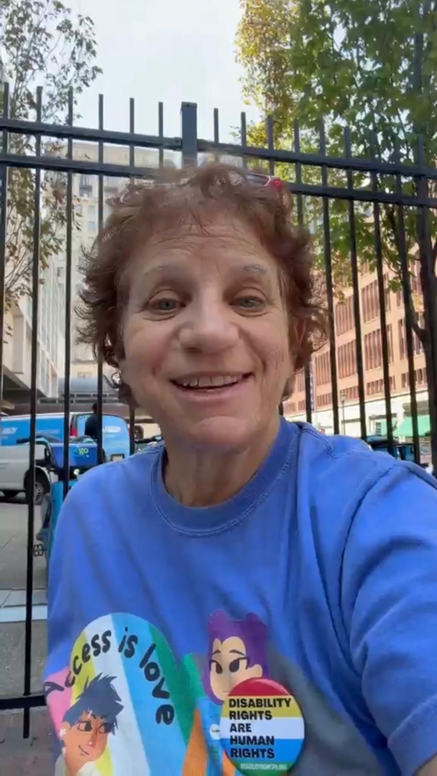 Angie Fuoco smiling outdoors while wearing a blue RCWDA shirt