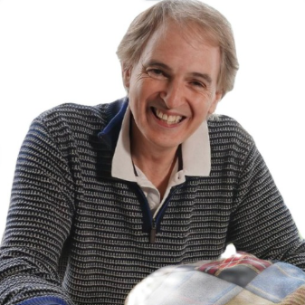 Portrait of Mark Stoddart smiling and wearing a grey sweater
