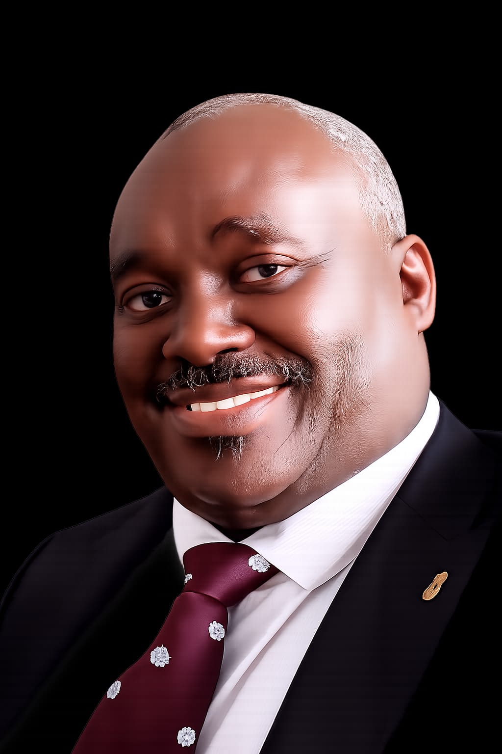 Formal portrait of Senator Harold Kipchumba wearing a dark suit and burgundy tie