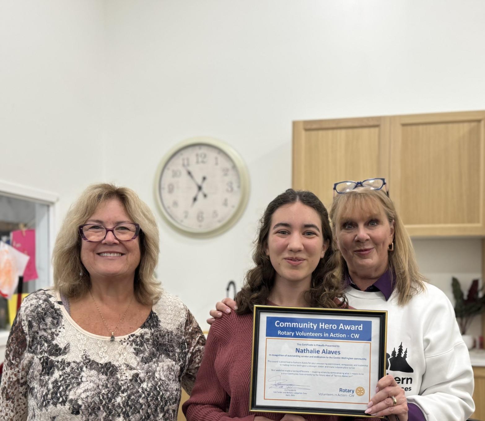 Image of 3 women, Nathalie in the centre receiving her award