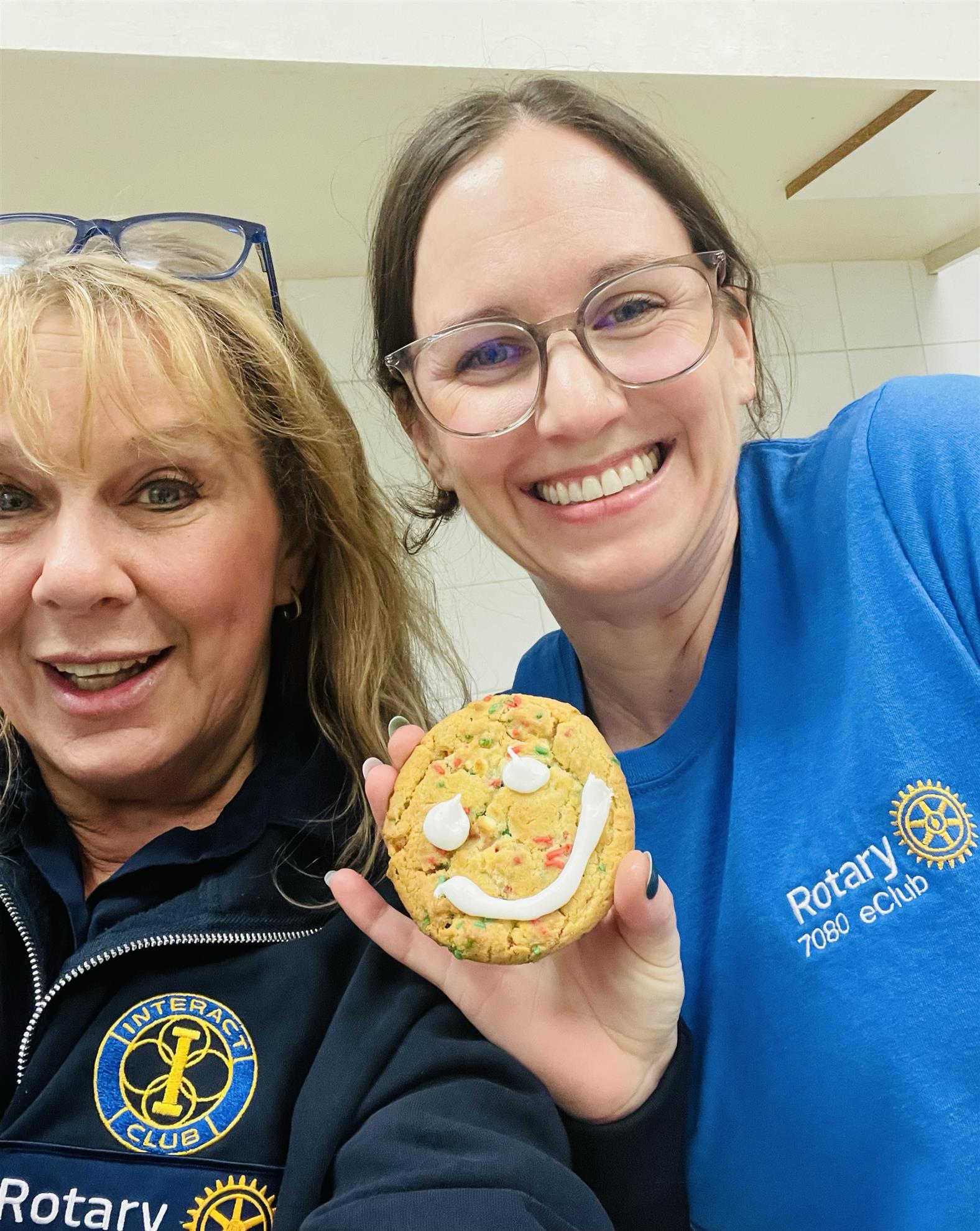 photo of Barb Lustgarten Evoy and Hillary Rooyakkers, holding up a smile cookie.