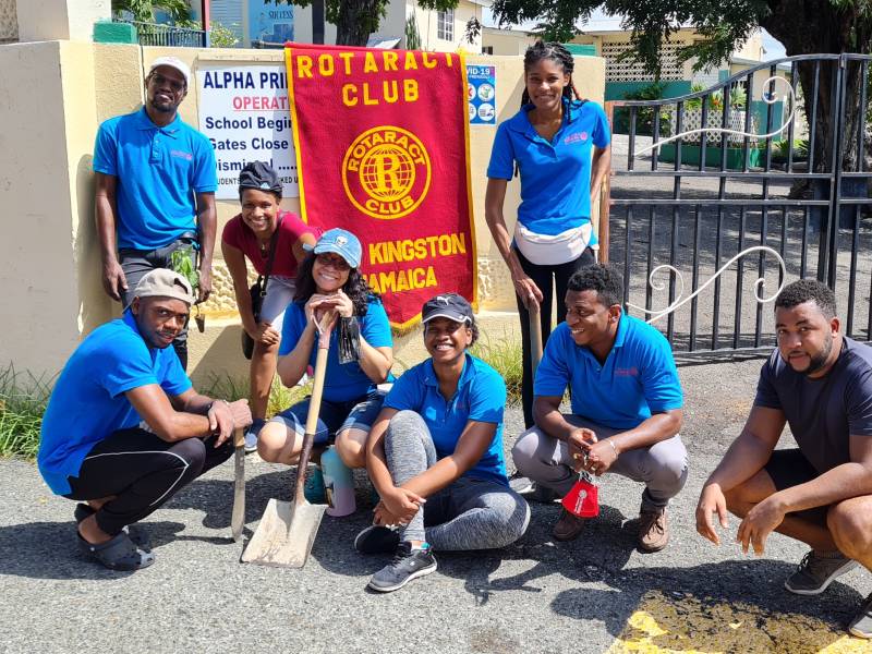 Club volunteers ready for community work outside a school