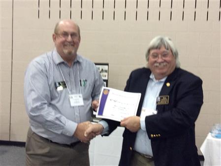 Sam Scroggins, District Public Image Chair, presents 1st Quarter Bulletin Contest Winner a Certificate of Accomplish to Texarkana Sunrise Rotary Club Bulletin Editor Ralph Waits. The club will receive 200 recognition points for winning the award.