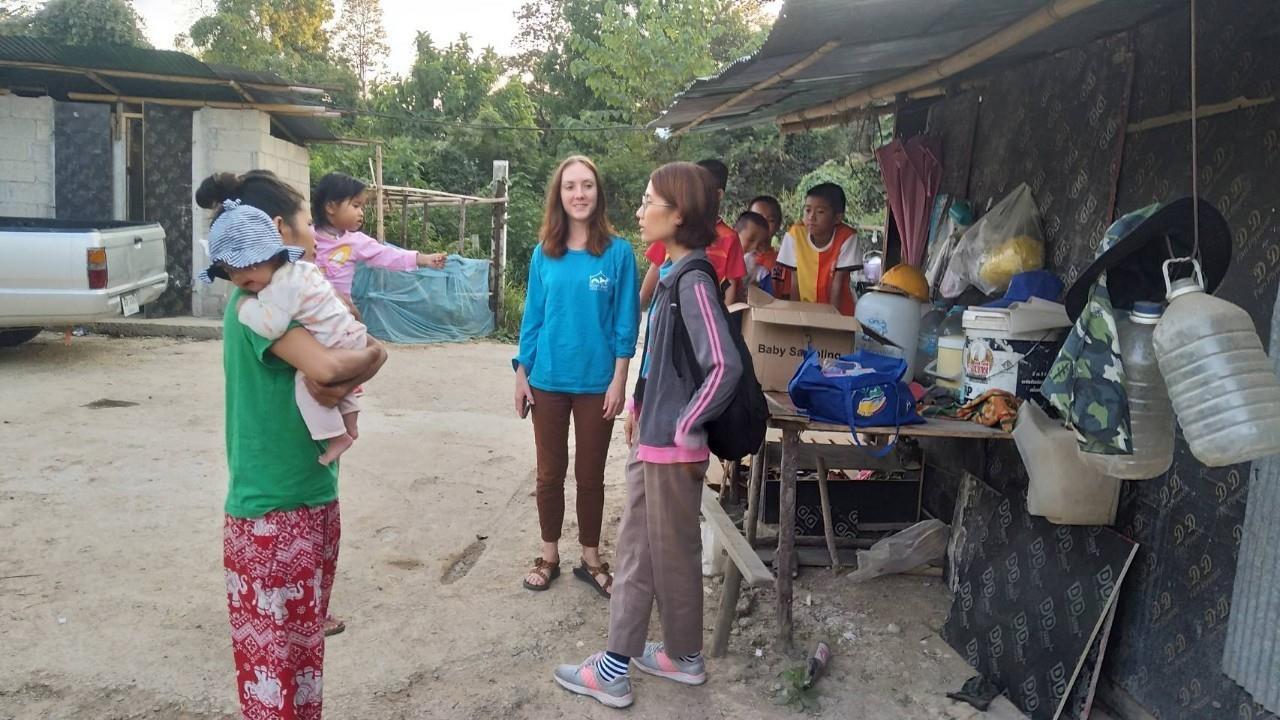 Sarah taking with a Laotian mother with child