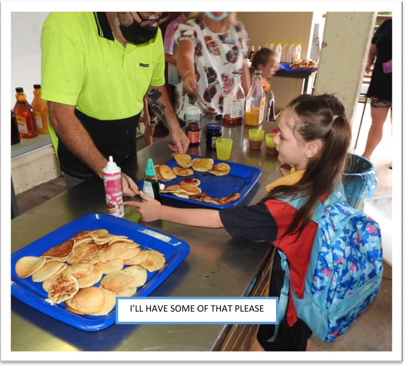 A child handing food to a personDescription automatically generated
