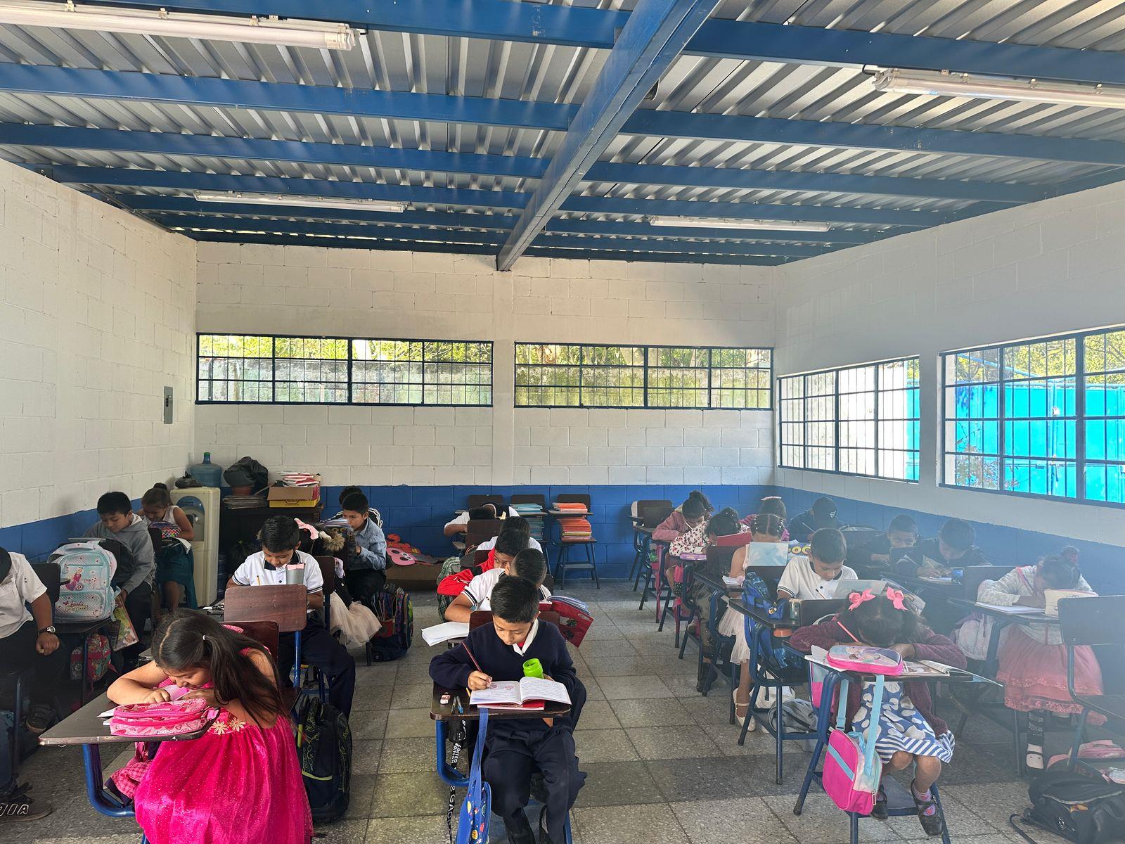 Students at desks working in a newly built classroom