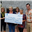 Members present a large donation check