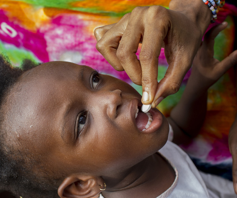 Child receives deworming medication often needed due to poor sanitation.