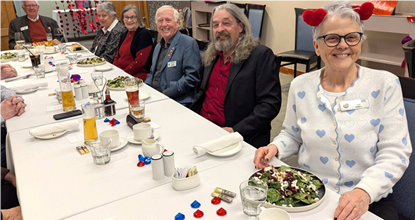 A group of people sitting at a tableDescription automatically generated