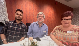 A group of people sitting at a tableDescription automatically generated