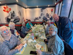 A group of people sitting at a tableDescription automatically generated